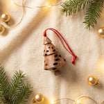 Close-up of natural Banksia seed pod texture on a handcrafted tiered Christmas ornament
