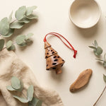 Banksia pod tiered Christmas tree decoration styled with eucalyptus leaves and linen