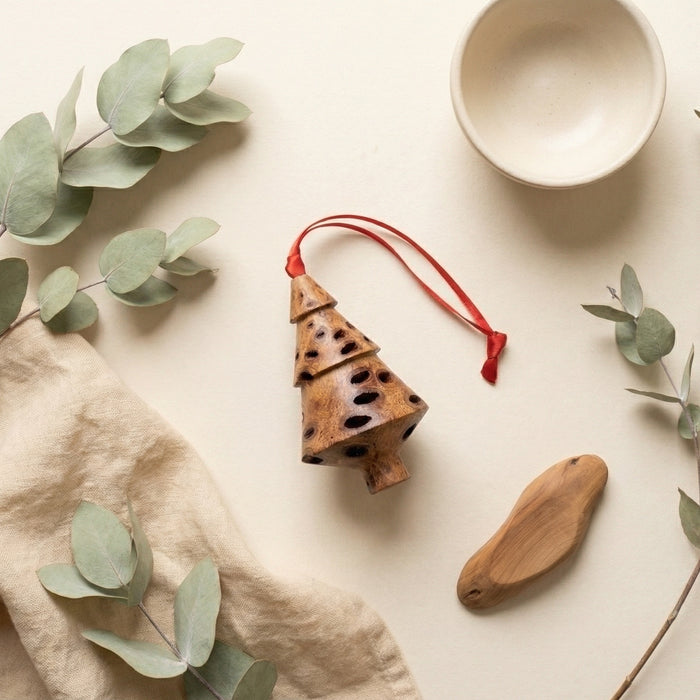 Banksia pod tiered Christmas tree decoration styled with eucalyptus leaves and linen